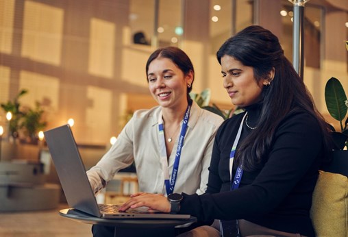 Two employees (women) working with laptop together