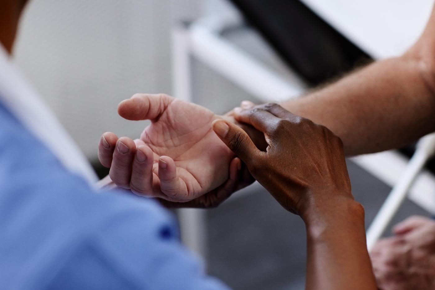 Female doctor checking patients pulse