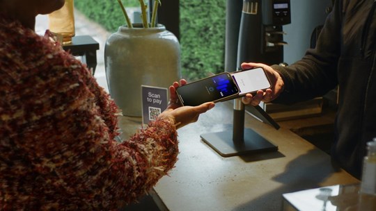 a close-up of a wireless payment transaction using a cell phone